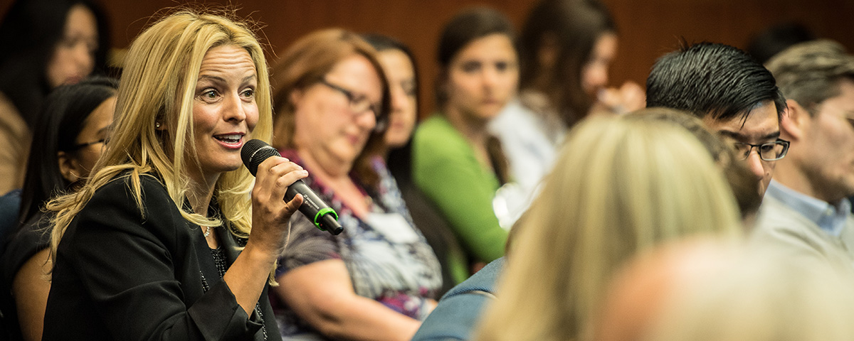 Woman at event on microphone