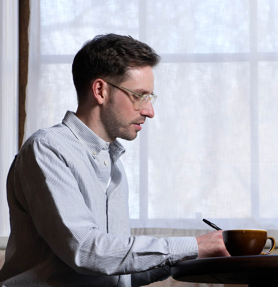 man looking down whilst writing