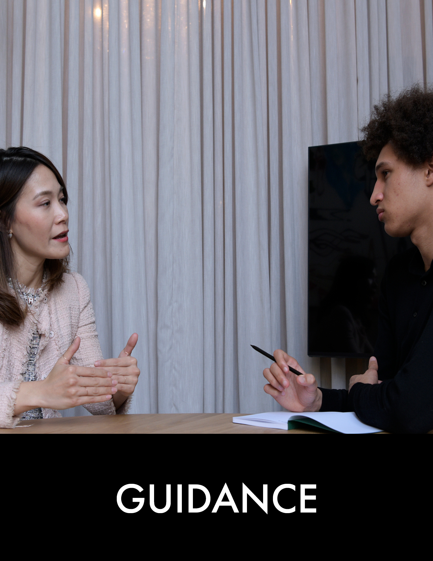 A woman and a man have a conversation at a table