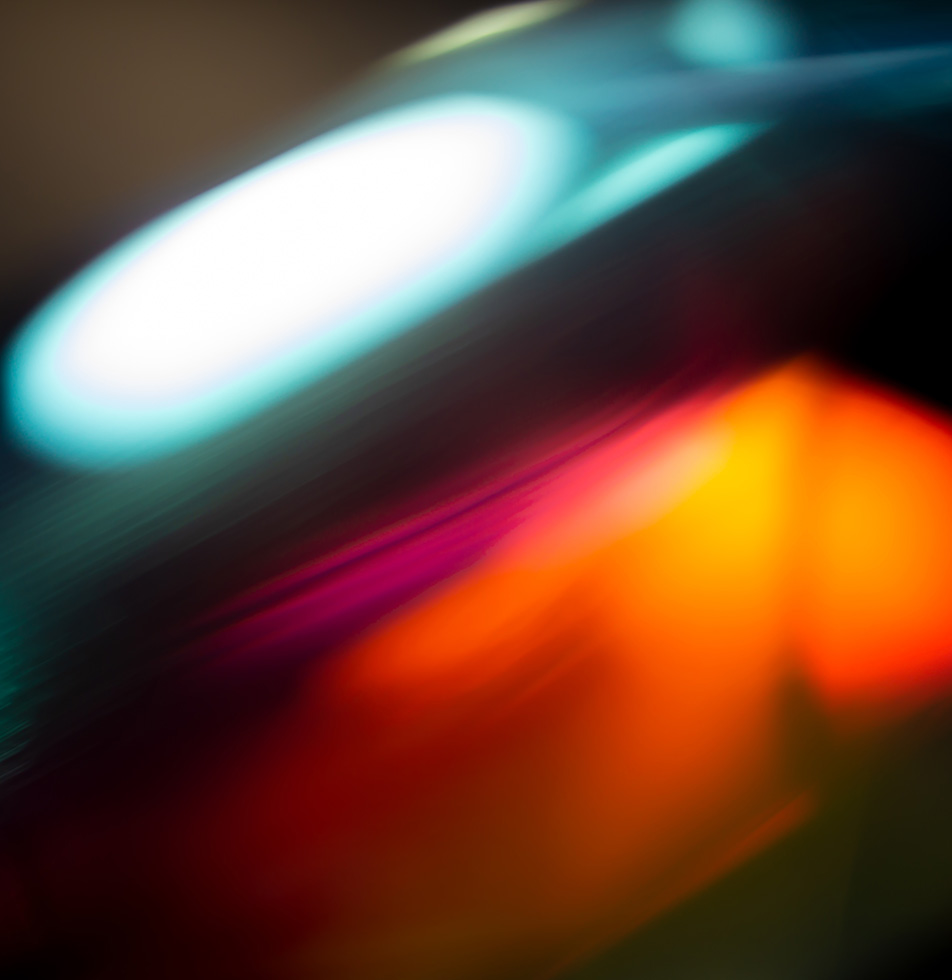 Abstract image, flashes of white and orange on a dark black background.  